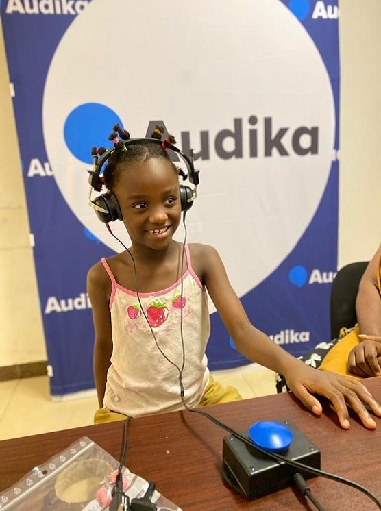 Une petite fille fait un test auditif avec les équipes Audika en mission humanitaire au Cameroun