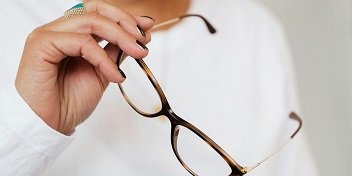Une paire de lunette tenue dans une main