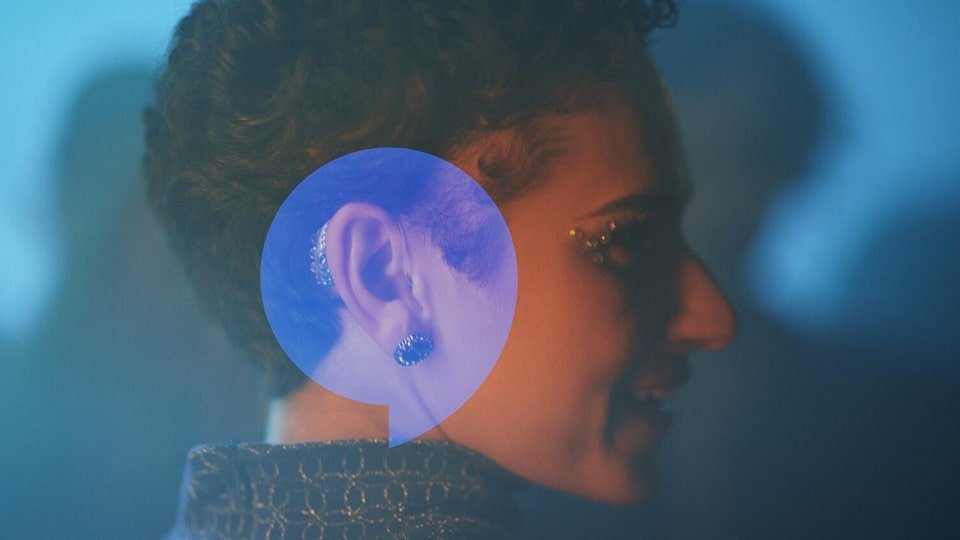 Une femme de profil portant des appareils auditifs en boîte de nuit 