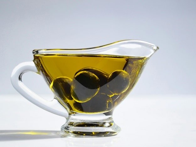 Tasse en verre contenant des olives et de l'huile d'olive