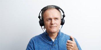 Bild på en man som testar sin hörsel efter att ha gjort ett quiz som indikerade på en hörselnedsättning