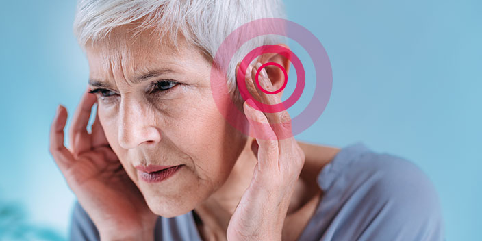 tinnitus woman holding ear