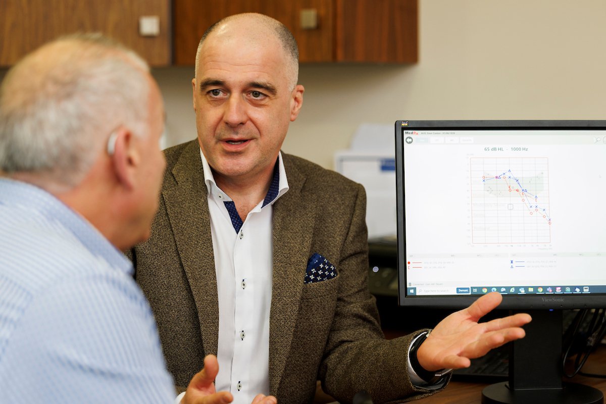 Audiologist showing patient his audiogram