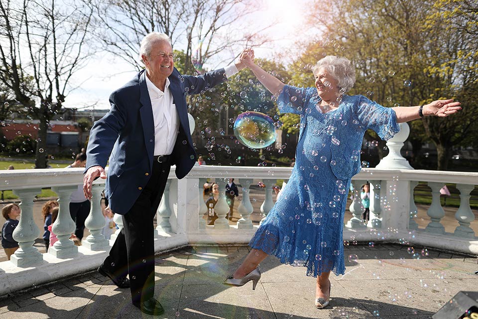 man and woman dancing with bubbles