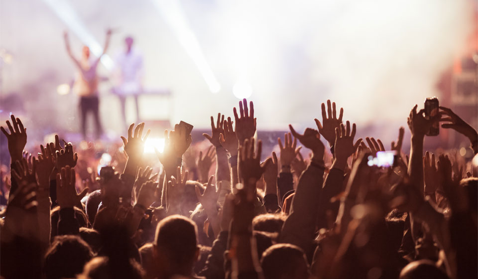 Image shows people at concert