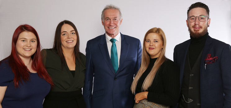 Image shows Dr Hilary Jones with Hidden Hearing staff