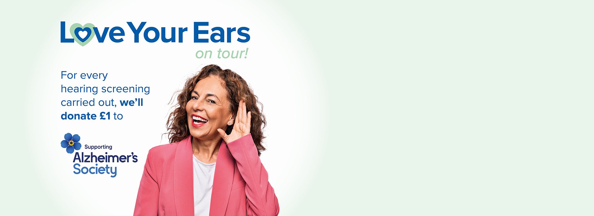 Image shows woman with headphone taking the online hearing test