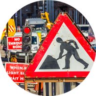 Image shows noisy roadworks and traffic that can be more irritating to those suffering from hearing loss