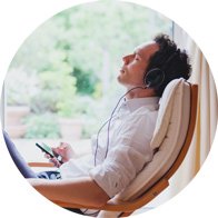 Image shows a man relaxing whilst listening to music