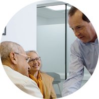 Image shows an audiologist introducing himself to Hidden Hearing customers