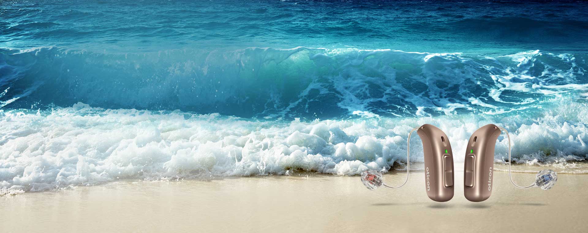 Image shows two hearing aids next to the sea
