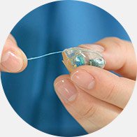 Image show hand cleaning a hearing aid