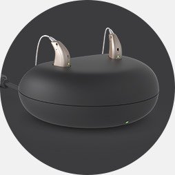 Image shows charging pod with hearing aids