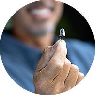 A man holding a hearing aid