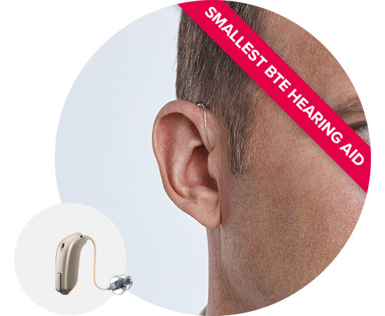 Image shows man wearing receiver-in-the-ear hearing aid