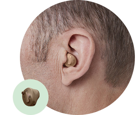Image shows In-the-ear half shell hearing aid in ear