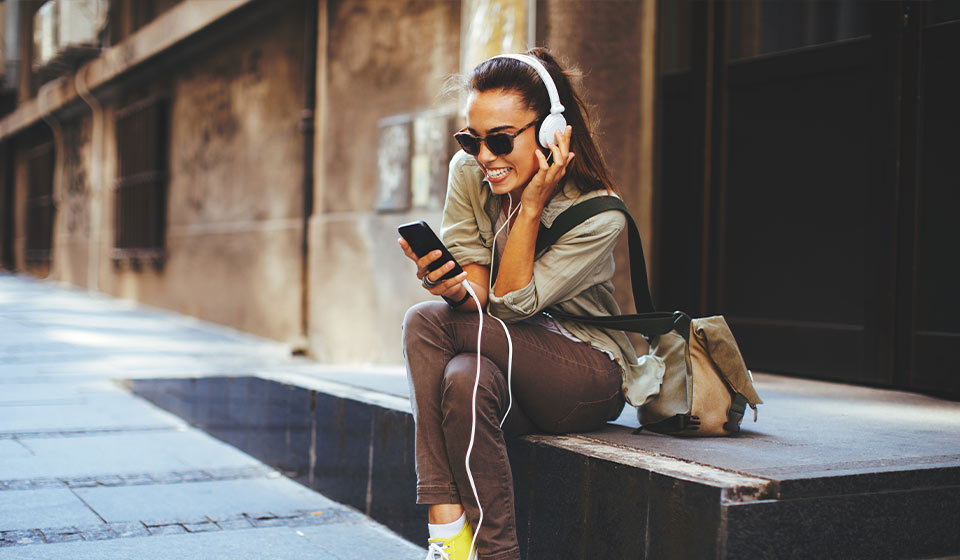 Afbeelding van vrouw die naar muziek luistert via koptelefoon